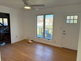 Empty room with hardwood floors and a ceiling fan.